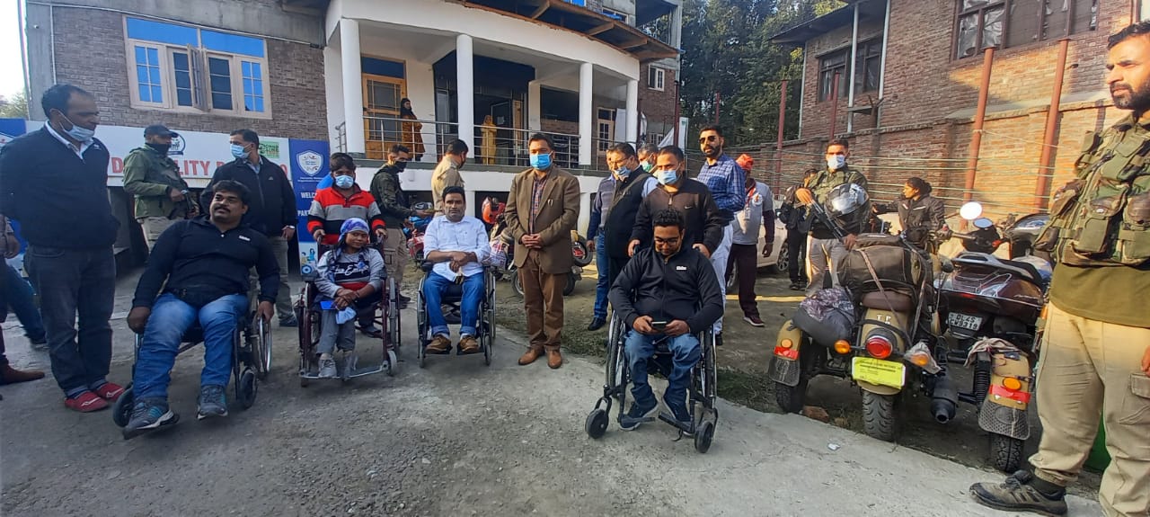 Team of Eagle Specially Abled Riders holding message of peace on hand controlled scooters received by DC Anantnag at Humanity Welfare organisation Helpline Bijbehara Kashmir